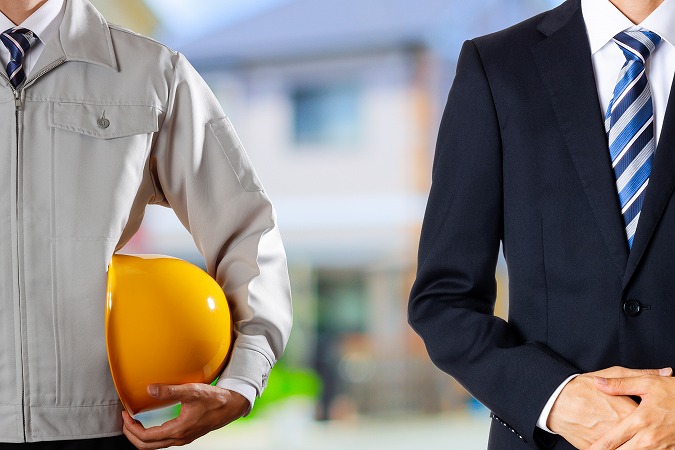 作業服とスーツの男性